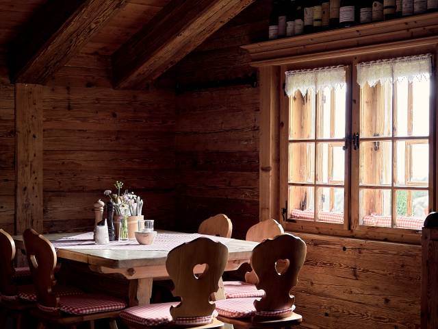Table with wooden chairs in a rustic mountain hut