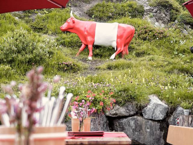 Sun terrace with view of decorative cow in the colors of the Austrian flag