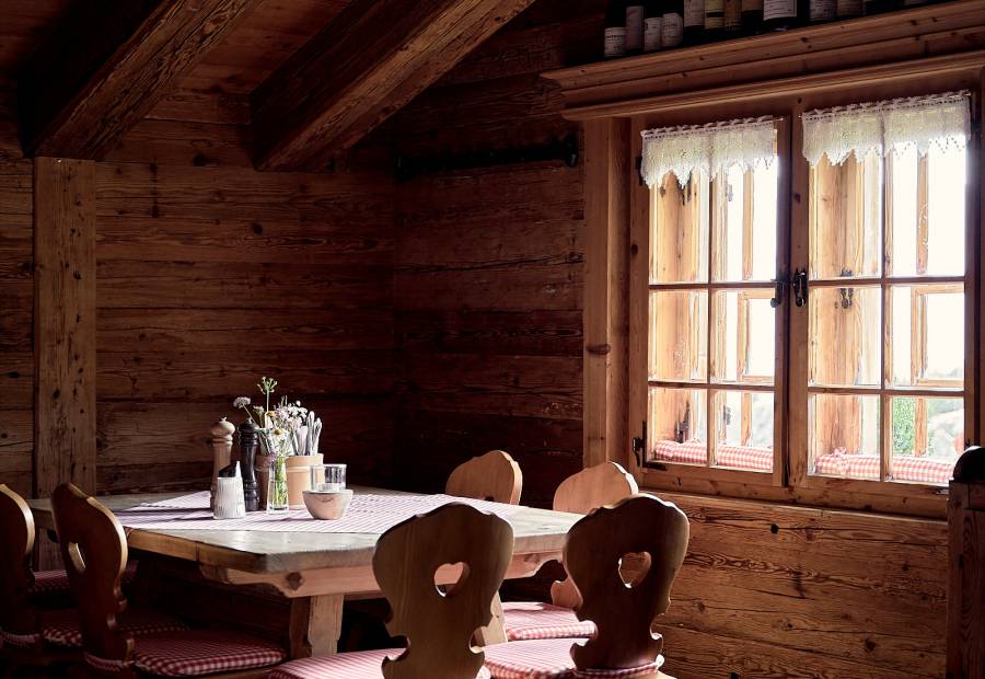 Table with wooden chairs in a rustic mountain hut